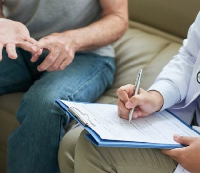 unrecognizable-doctor-talking-to-patient-at-home-and-making-notes_1098-20641 1.jpg